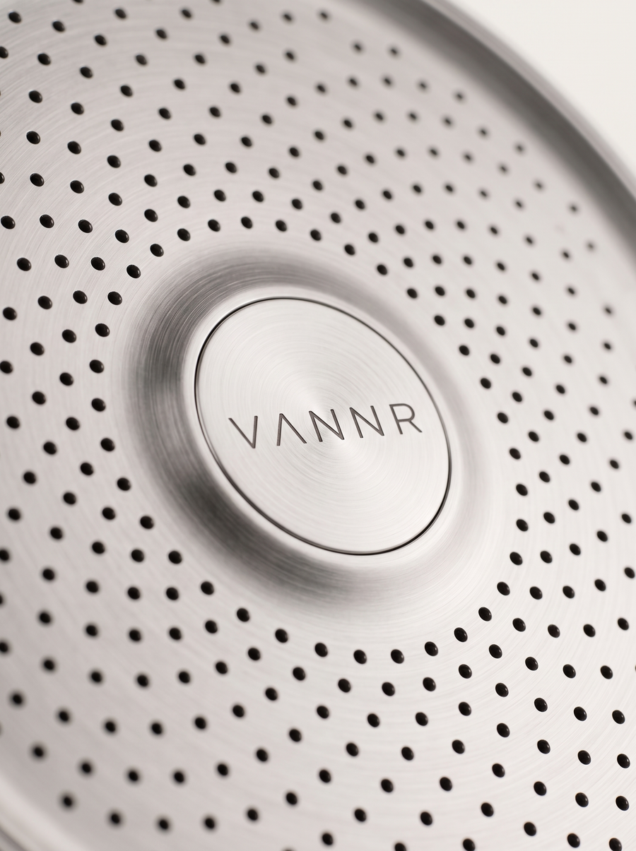 Macro detail of the perforated spray face and the etched VANNR wordmark.