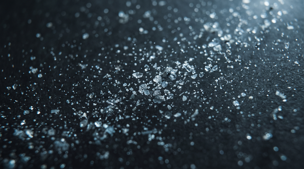 Abstract macro of fine mineral particles suspended in water.